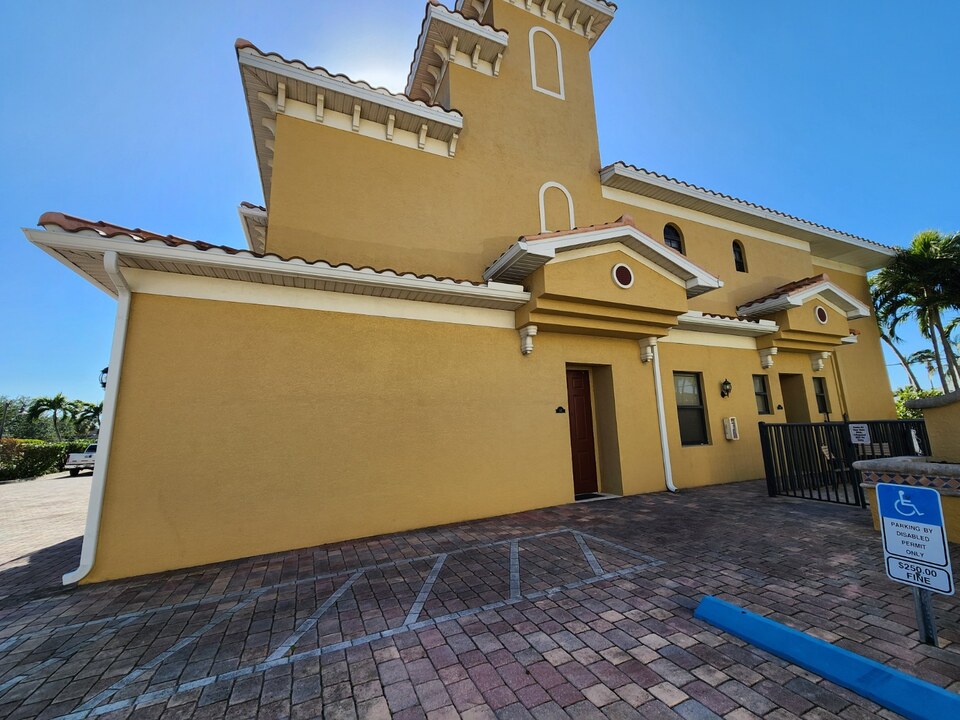 Commercial building side view with garage bays after professional exterior repainting in Cape Coral, FL — H Calix Stucco Design & Paint LLC.