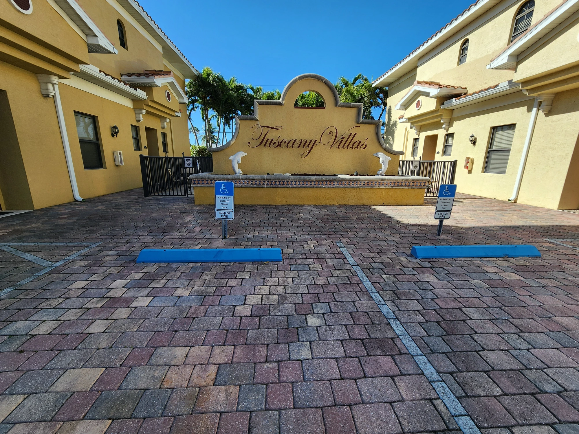 Corner view of commercial exterior with tower, tile roof and refreshed stucco in Cape Coral, FL — H Calix Stucco Design & Paint LLC.