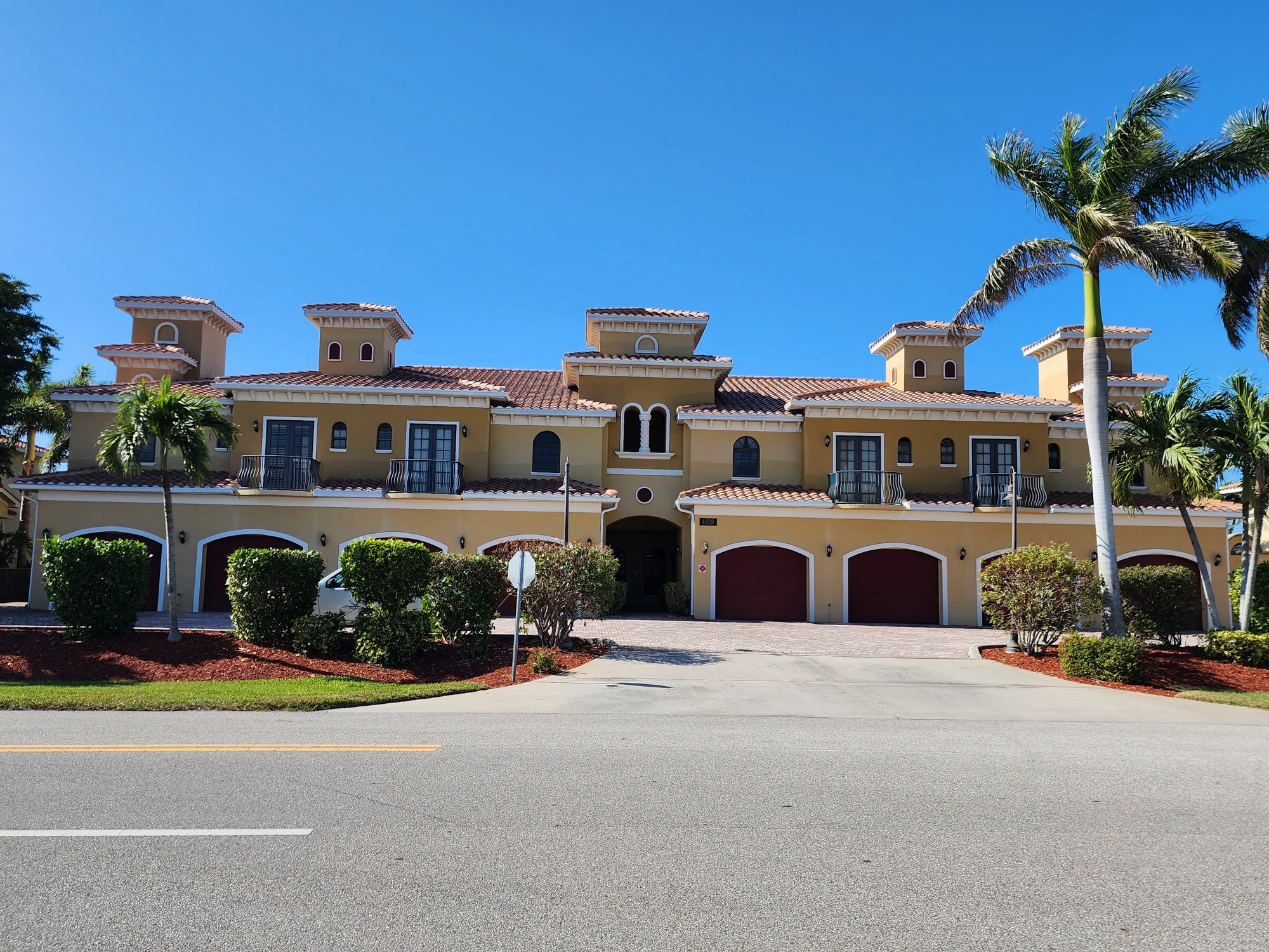 Multi-story commercial exterior wall with restored stucco and clean finish paint in Cape Coral, FL — H Calix Stucco Design & Paint LLC.