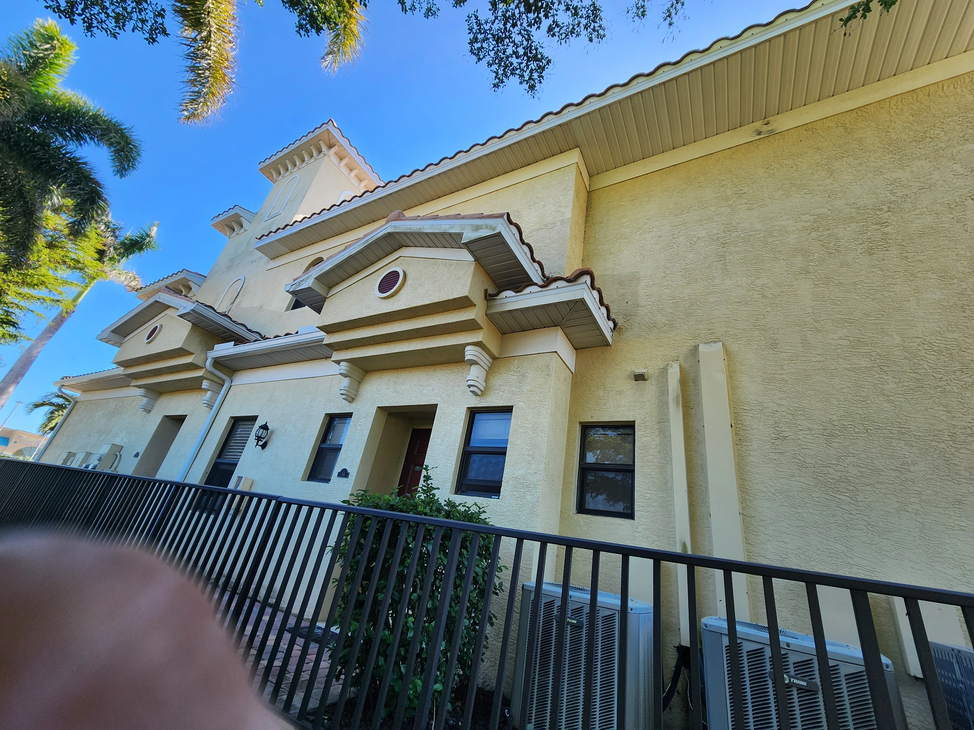 Architectural trim, cornices and stucco walls on commercial building after professional repainting in Cape Coral, FL — H Calix Stucco Design & Paint LLC.