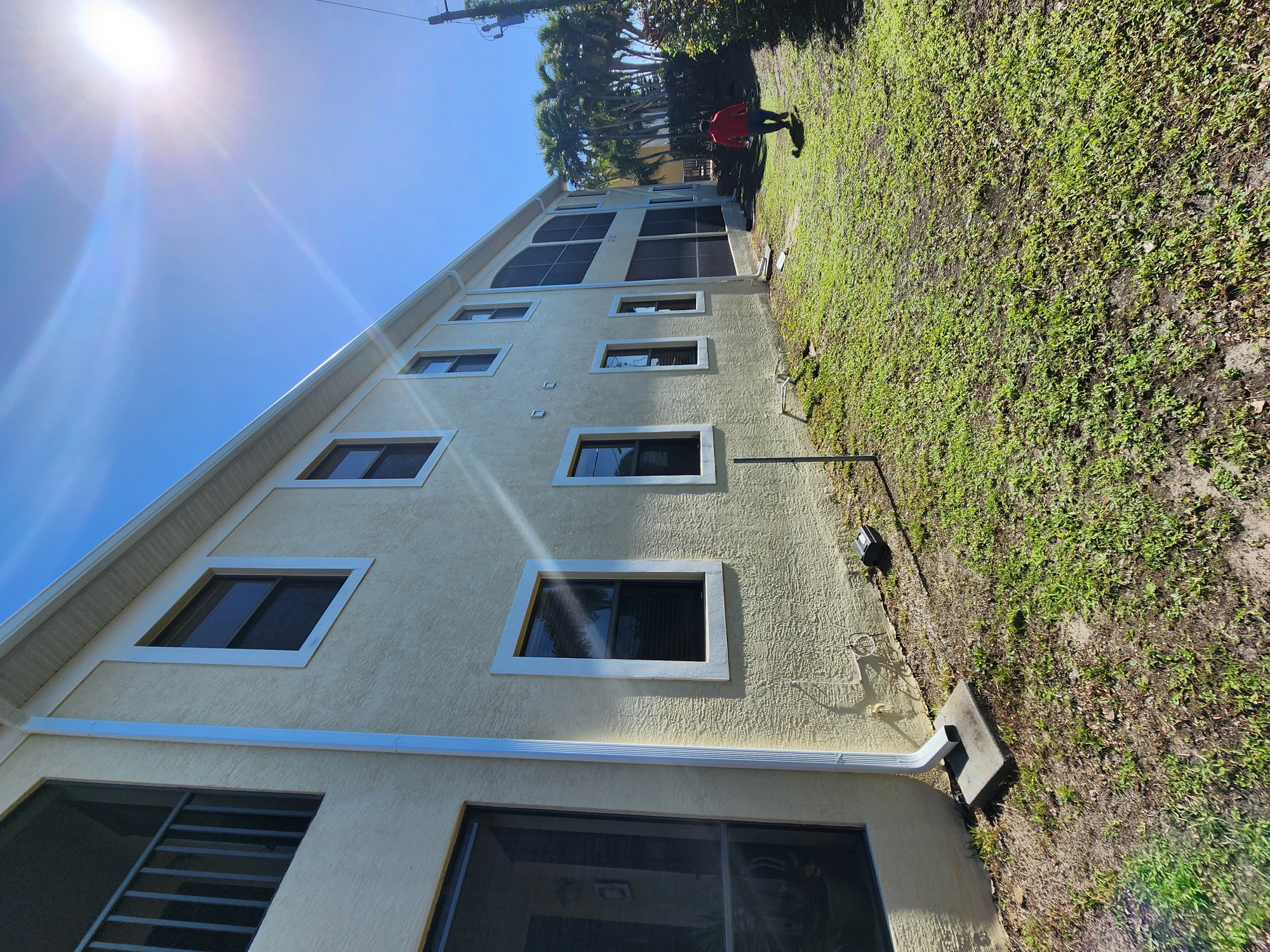 Full front facade of commercial complex after exterior repainting and stucco restoration in Cape Coral, FL — H Calix Stucco Design & Paint LLC.