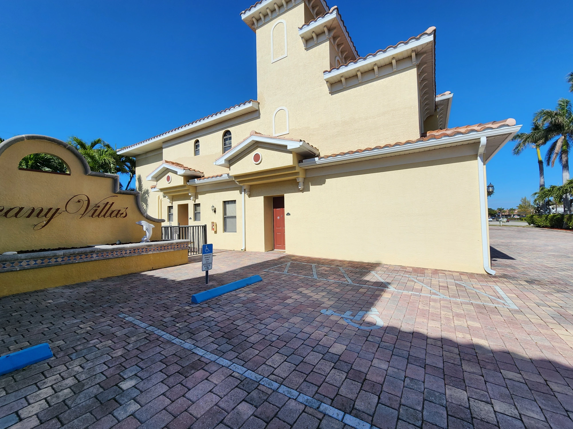 Commercial building entrance signage area with fresh exterior paint and stucco repairs in Cape Coral, FL — H Calix Stucco Design & Paint LLC.