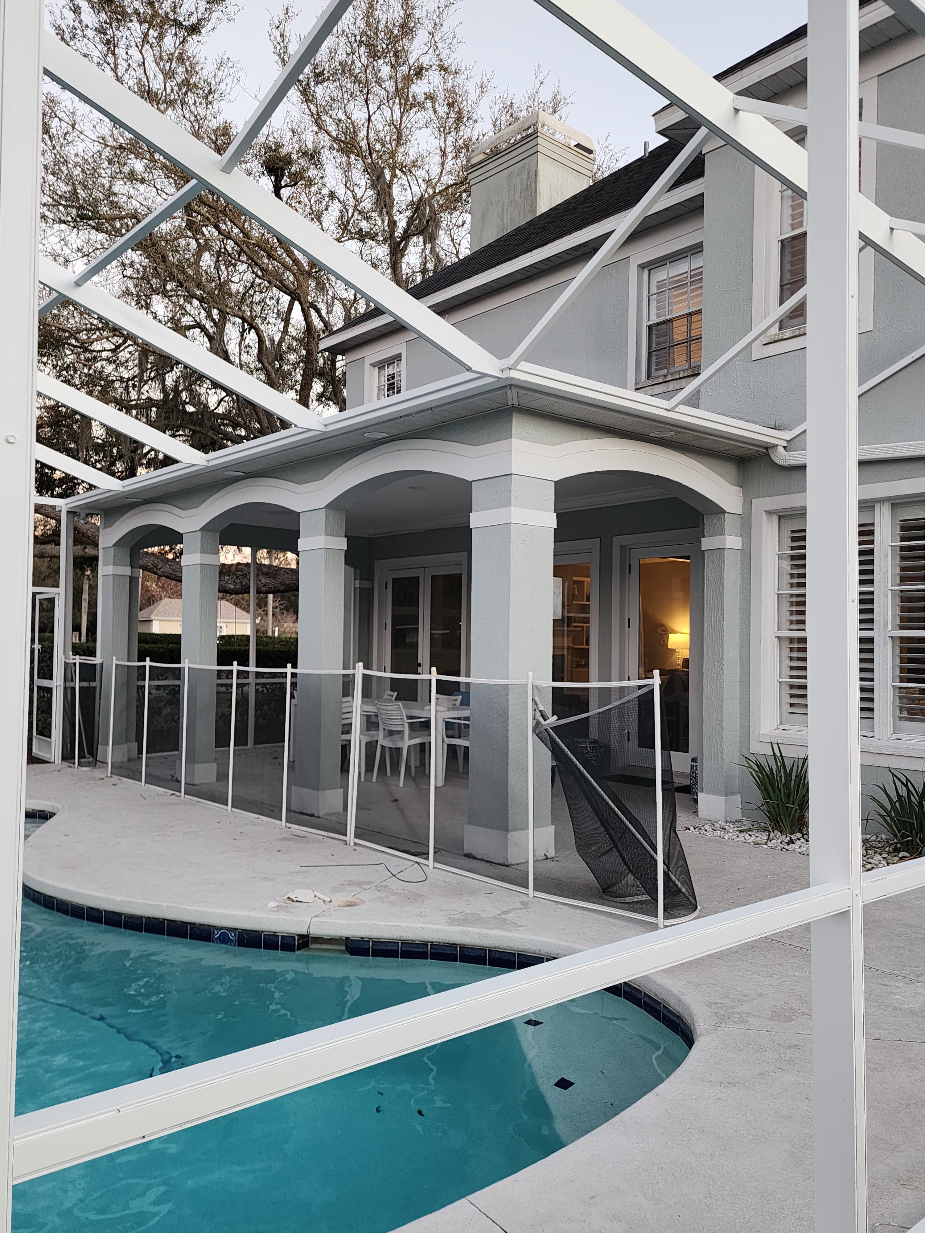 Professional pool cage painting and screen enclosure restoration in Lutz FL by H Calix Stucco Design & Paint LLC — completed pool enclosure with long-lasting professional finish