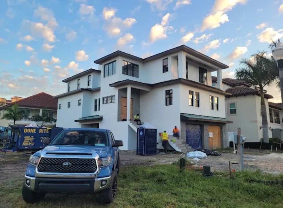 Modern residential facade with smooth white stucco finish, brick accents and painted trim in St. Petersburg, FL — H Calix Stucco Design & Paint LLC.