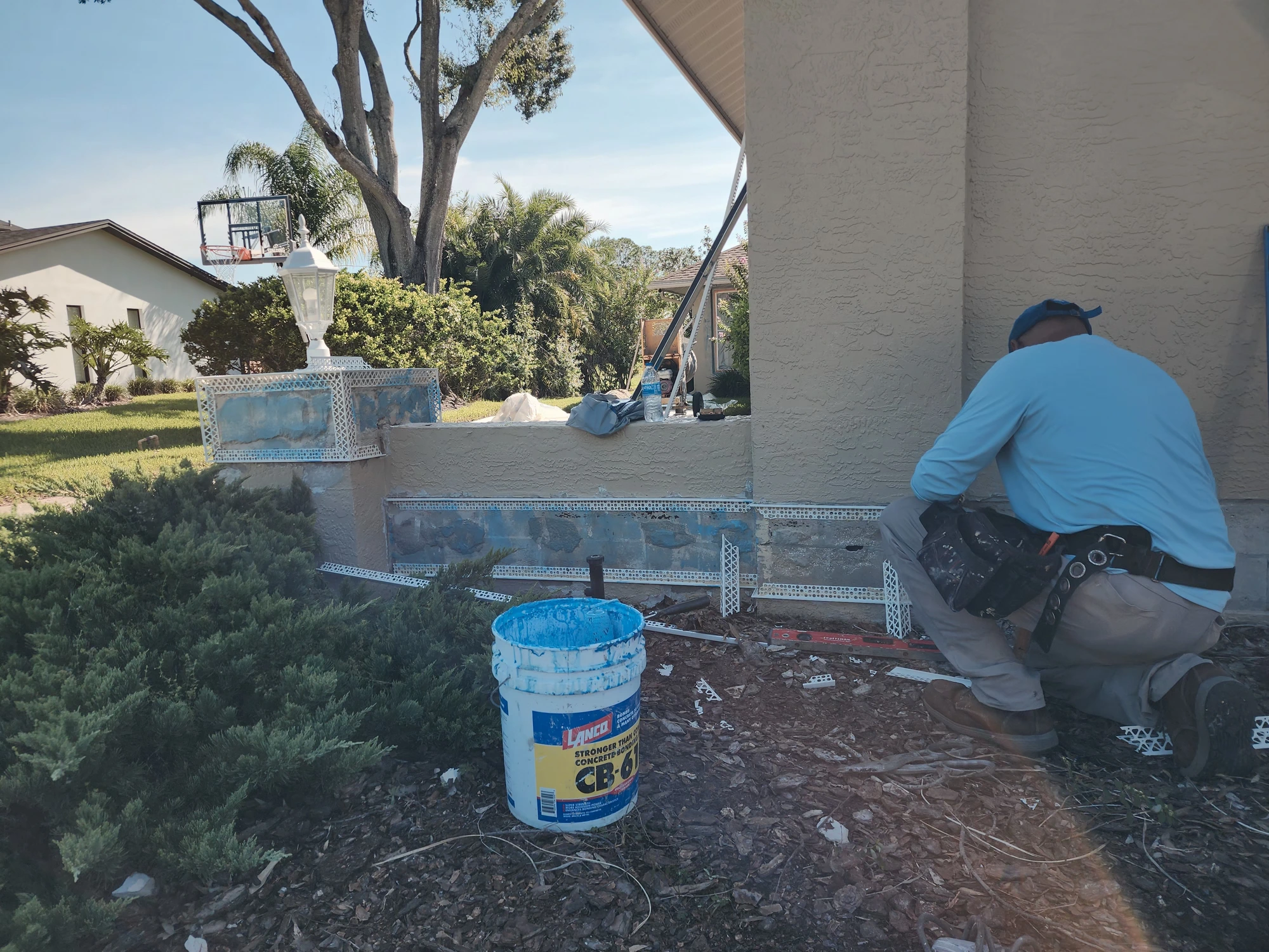 Stucco molding repair and rusted metal corner bead replacement with vinyl corner beads in Tampa, Florida.