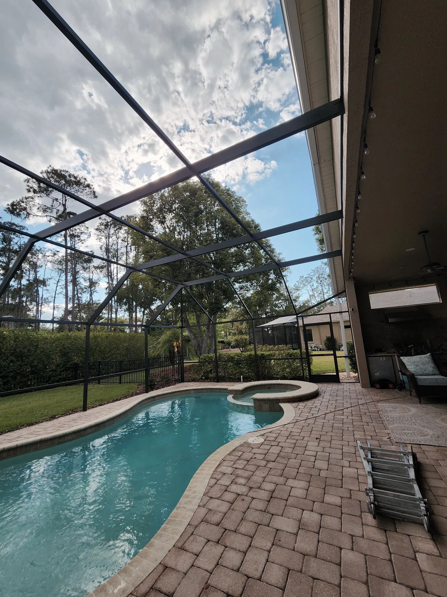 Professional pool cage painting and screen enclosure restoration in Wesley Chapel, Florida by H Calix Stucco Design & Paint LLC — finished interior view with clean, durable coating