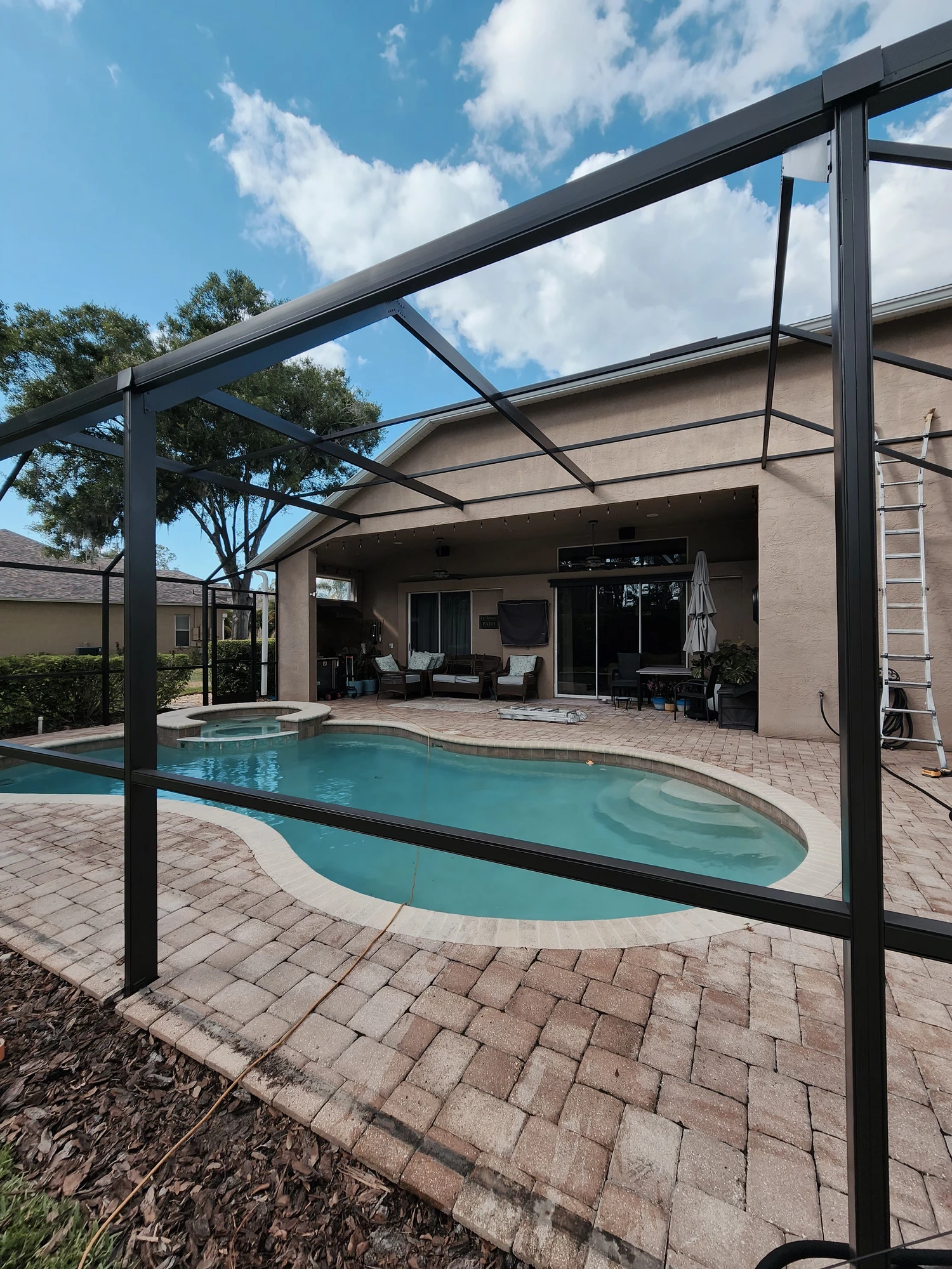 Professional pool cage painting and screen enclosure restoration in Wesley Chapel, Florida by H Calix Stucco Design & Paint LLC — completed screen enclosure with long-lasting finish