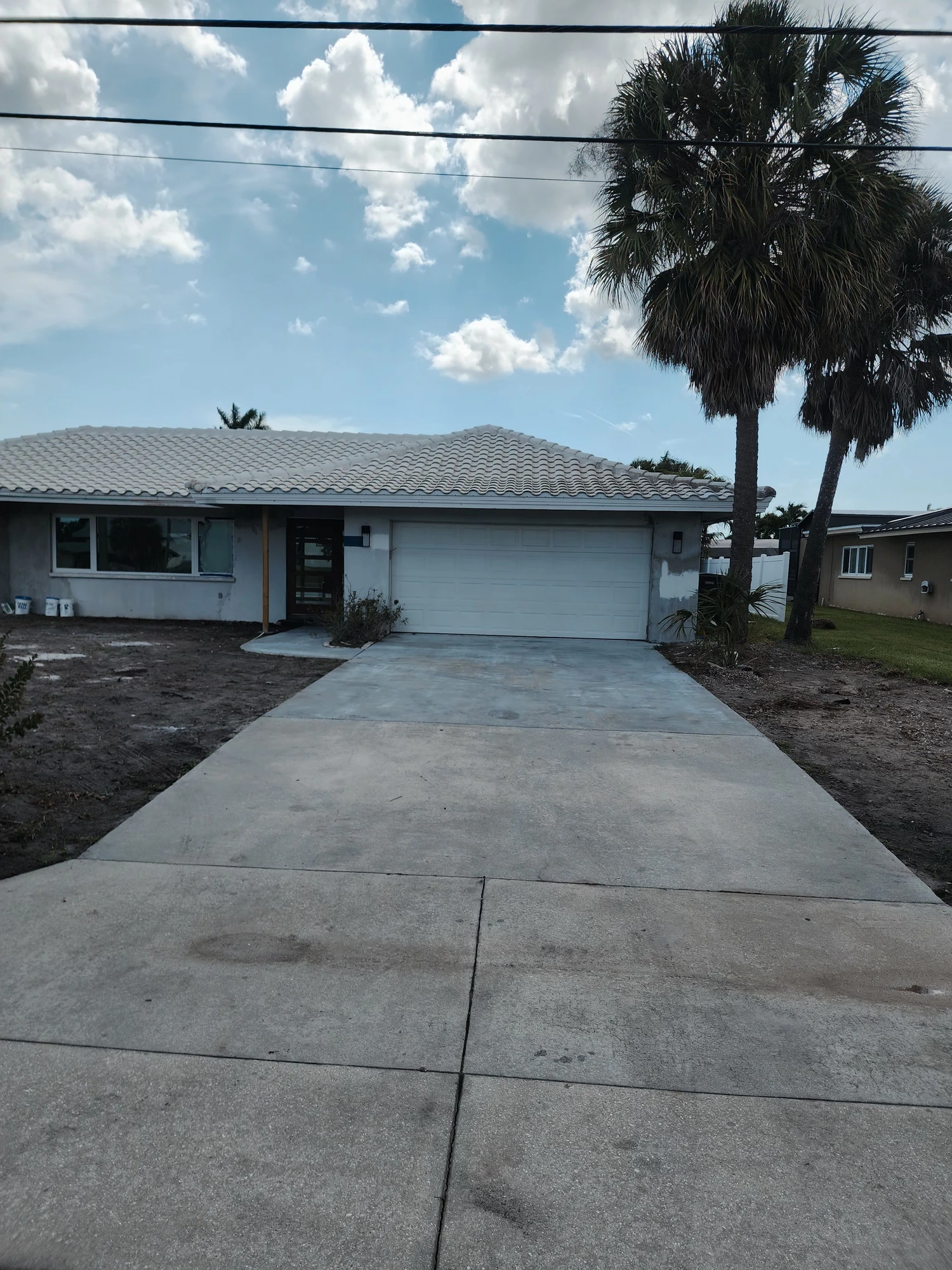 Front of residential home with clean driveway and exterior after professional pressure washing in Zephyrhills, FL — H Calix Stucco Design & Paint LLC.