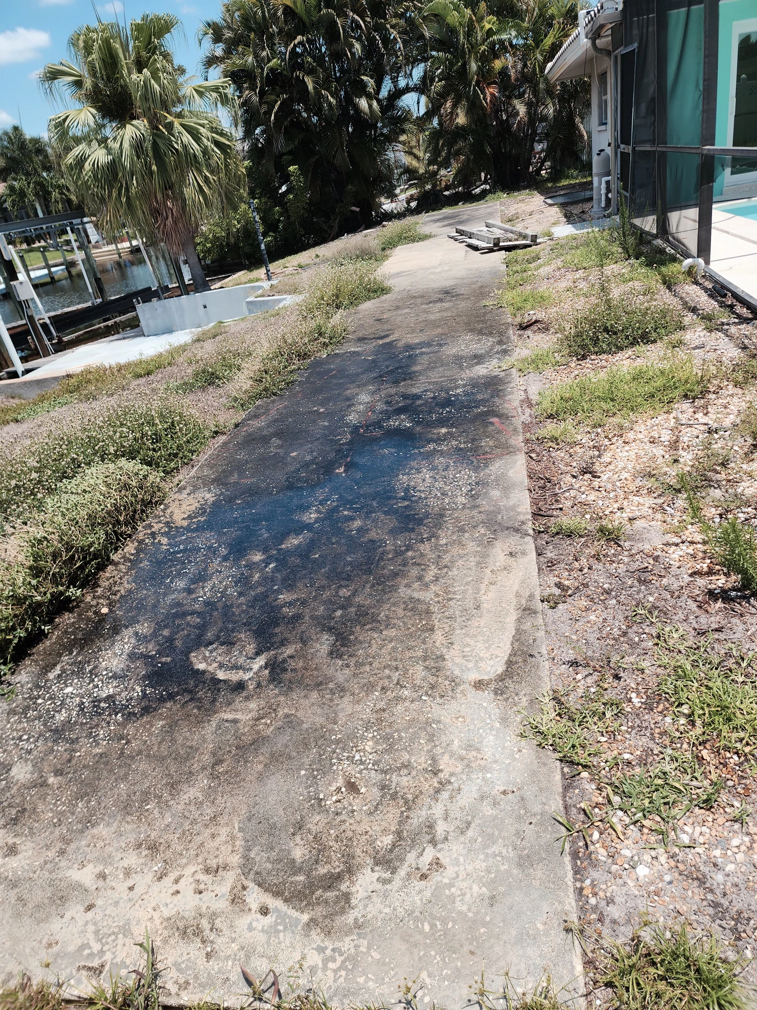 Dirty exterior walkway with heavy dirt, mold and mildew buildup before professional pressure washing in Zephyrhills, FL — H Calix Stucco Design & Paint LLC.